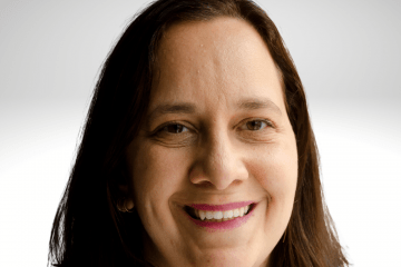 Gili Segal has long brown hair and is wearing pink shirt