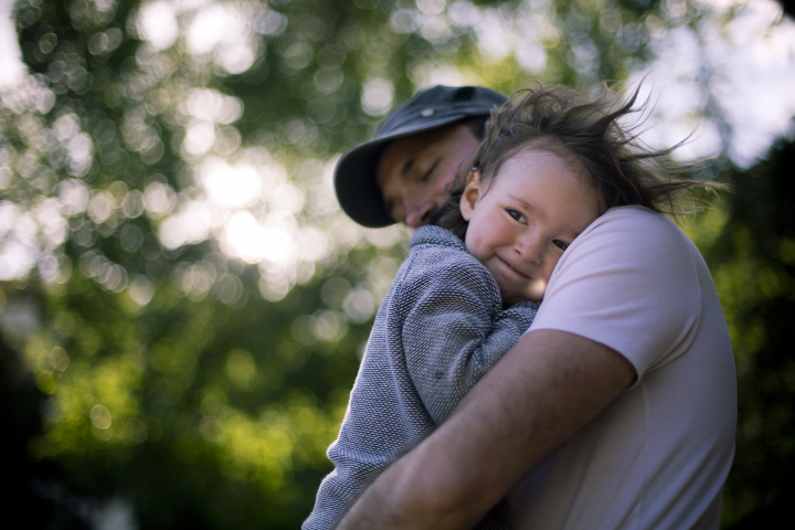 Father hugging his child outdoors.
