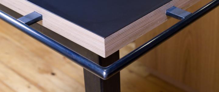 Photo zoomed in to show features of custom grad rail wrapping around corner of island bench in kitchen