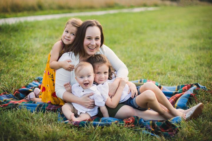 Emily (mother) hugging daughters and Owen