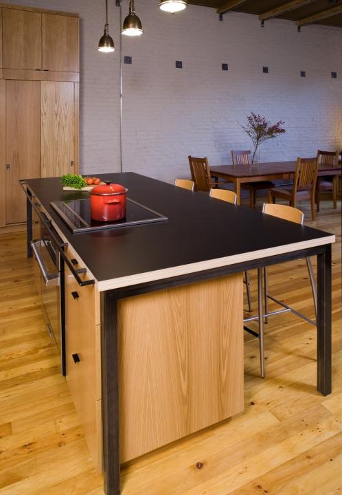 Photo of island bench with black custom grab rail on edge