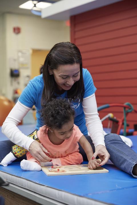 Briana in therapy playing a game.