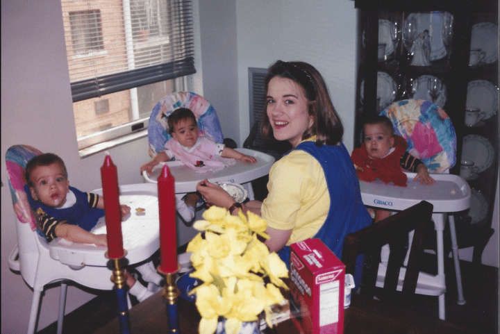 Mom feeding her three babies