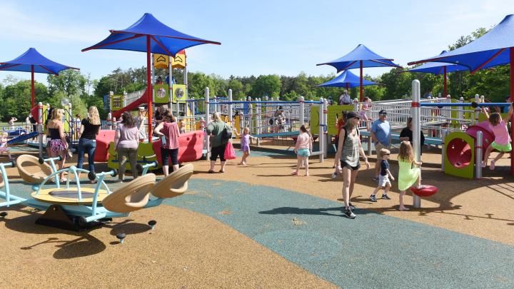 Picture of adults and children on an outdoor playground