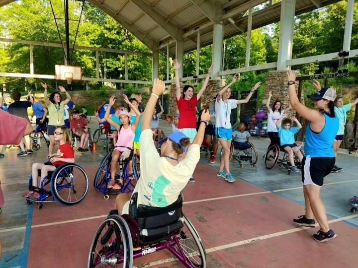 Individuals in wheelchairs participating in a fitness class