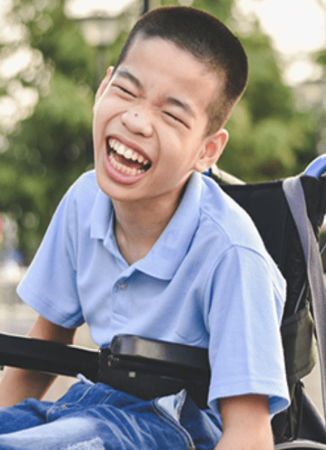 Photo of a boy in a blue shirt in a wheelchair