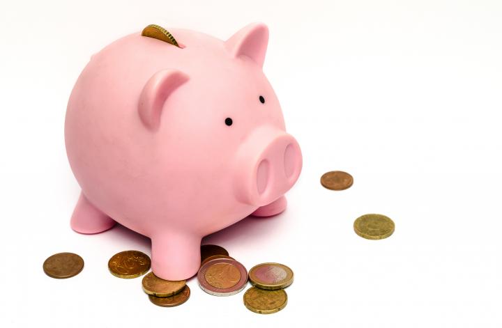 Pink Piggy Bank with Penny's Scattered around