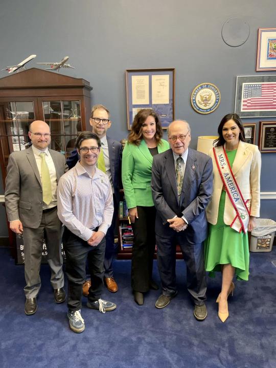Six men and women in a congressional office