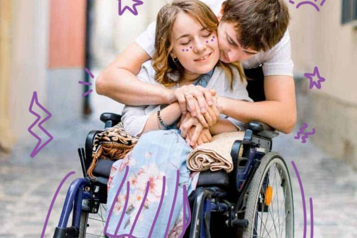 Image of a young woman in a wheelchair being hugged by a young man