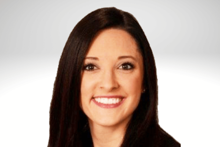 Danielle Lemke has long dark brown hair and is smiling. She is wearing a black blazer.