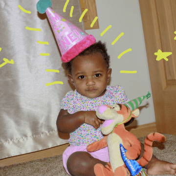 Tylynn one year old, with pink birthday hat on