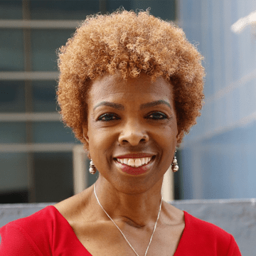 Photo of Dr. Lisa Thornton smiling at the camera wearing a red top