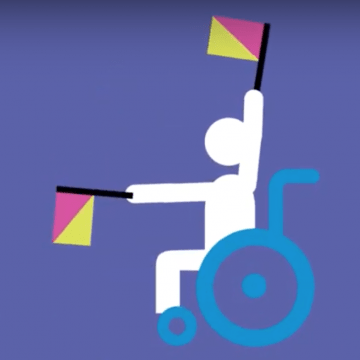 Child in wheelchair raising flags