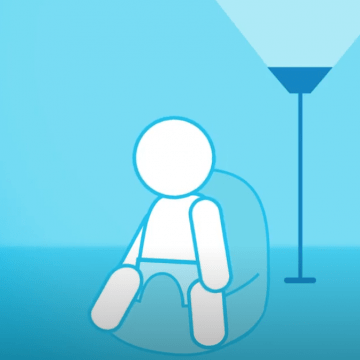 Representation of an infant seated near a lamp