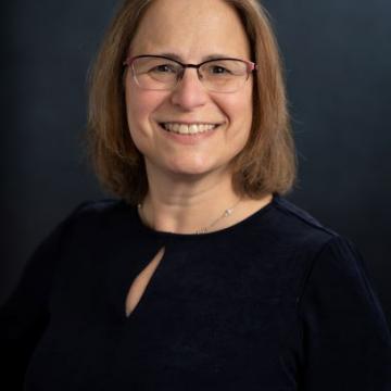Photo of Amy Bailes in a black shirt on a black background