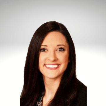 Danielle Lemke has long dark brown hair and is smiling. She is wearing a black blazer.