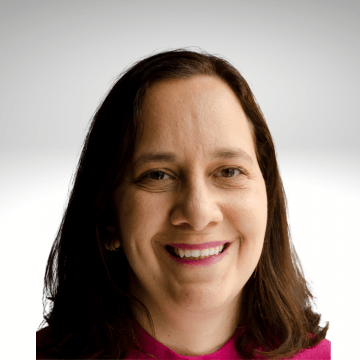 Gili Segal has long brown hair and is wearing pink shirt