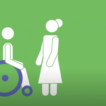 Illustration of a person in a purple wheelchair about to be transferred to standing by a woman standing in front of them. They are drawn on a green background.