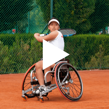 Thumbnail of woman in wheelchair playing a sport with play button overlayed