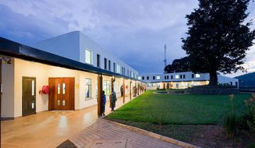Photo of Butaro Hospital at Dusk with wide walkways and ramp to entrance