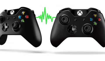 Photo of two xbox controllers connected by a green squiggly line.