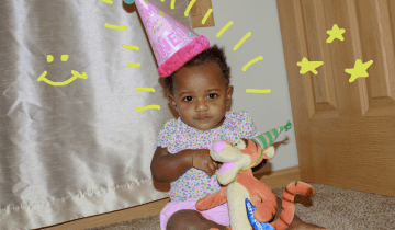 Tylynn one year old, with pink birthday hat on