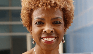 Photo of Dr. Lisa Thornton smiling at the camera wearing a red top