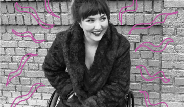 A young woman sits in front of a brick wall in a wheel chair smiling off to the right. Drawn pink squiggles surround her.