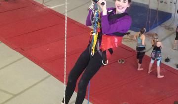 Young woman participating in adaptive rock climbing