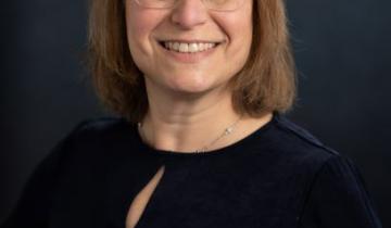 Photo of Amy Bailes in a black shirt on a black background