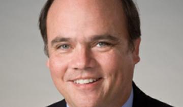 Photo of Dr. Hank Chambers wearing a black sport jacket and tie.