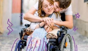Image of a young woman in a wheelchair being hugged by a young man