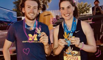 Male and Female athletes wearing blue University of Michigan shirts holding award medals