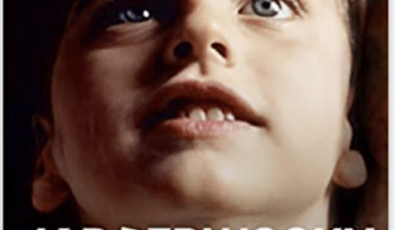 Photo of the face of a young boy with blue eyes that reads Jabberwocky: Lessons of Love from A Boy Who Never Spoke