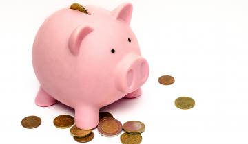 Pink Piggy Bank with Penny's Scattered around