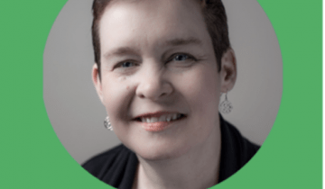 Kathleen Friel, PhD with short brown hair, smiling wearing a black shirt surrounded by a green circle with the inscription Cerebral Palsy Foundation, 2021 National CP research awareness award