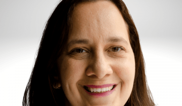 Gili Segal has long brown hair and is wearing pink shirt