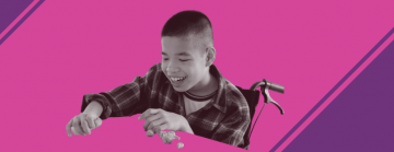 Asian boy in wheelchair playing with clay on a pink and purple background