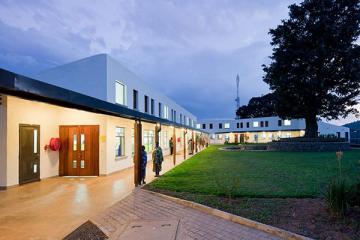Photo of Butaro Hospital at Dusk with wide walkways and ramp to entrance