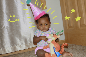 Tylynn one year old, with pink birthday hat on
