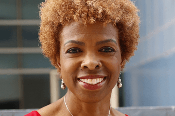 Photo of Dr. Lisa Thornton smiling at the camera wearing a red top