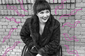 A young woman sits in front of a brick wall in a wheel chair smiling off to the right. Drawn pink squiggles surround her.