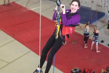 Young woman participating in adaptive rock climbing