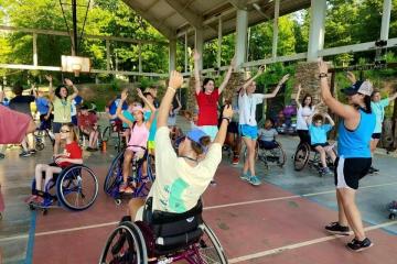 Individuals in wheelchairs participating in a fitness class
