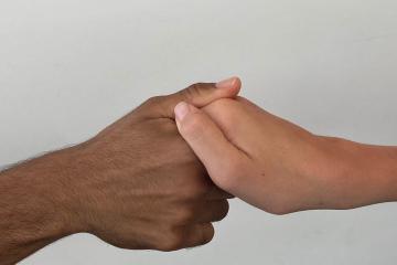 Photo of hands shaking.