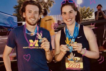 Male and Female athletes wearing blue University of Michigan shirts holding award medals